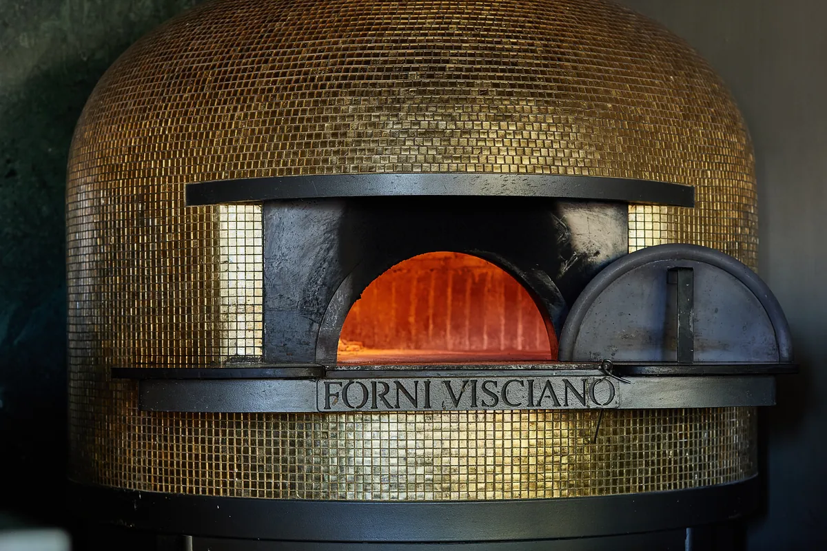 The gold mosaic dome and the FORNI VISCIANO plate