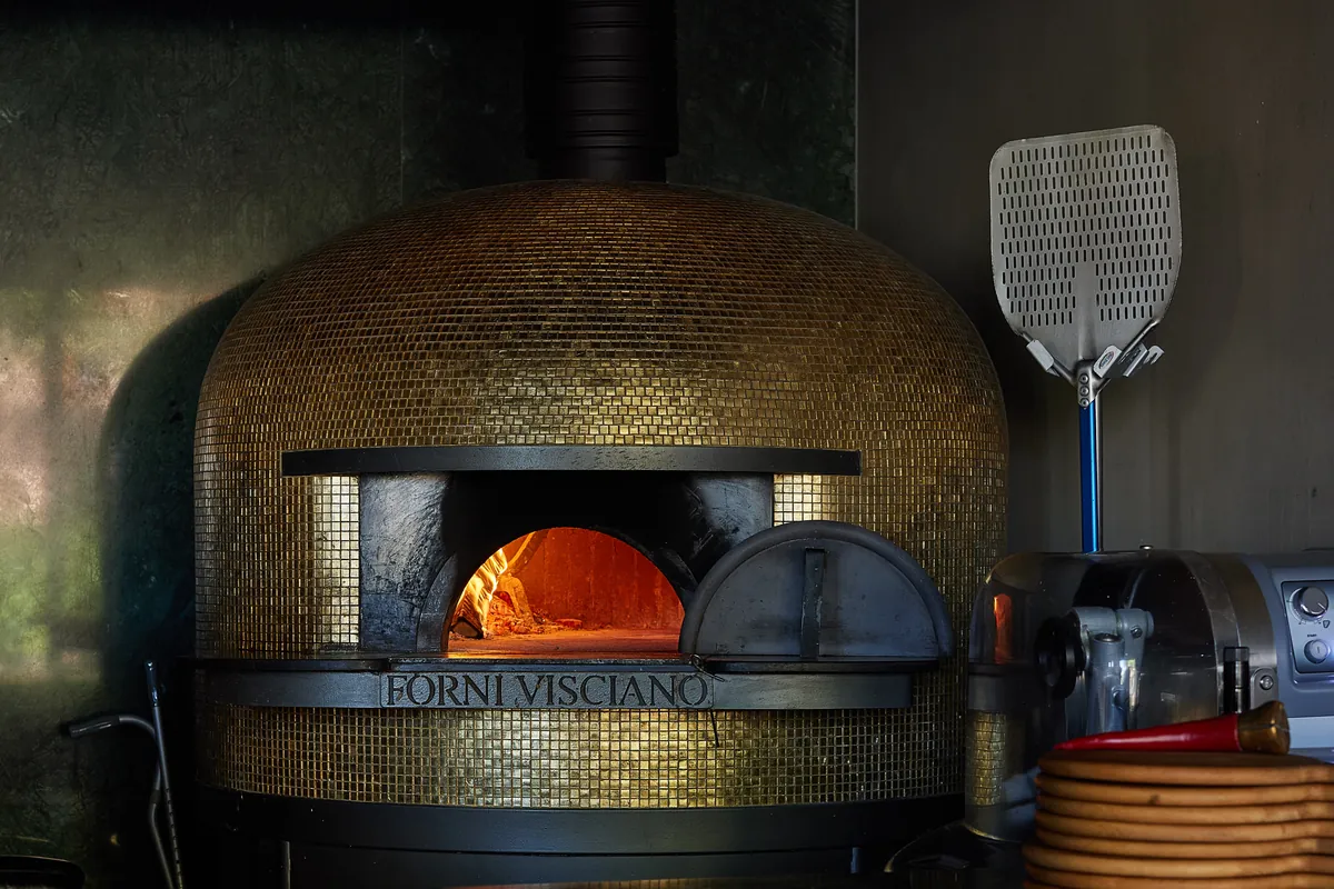 The gold oven, its chimney and a peel beside it