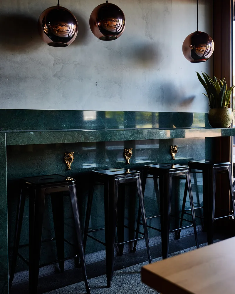 The bar with copper lamps and stools