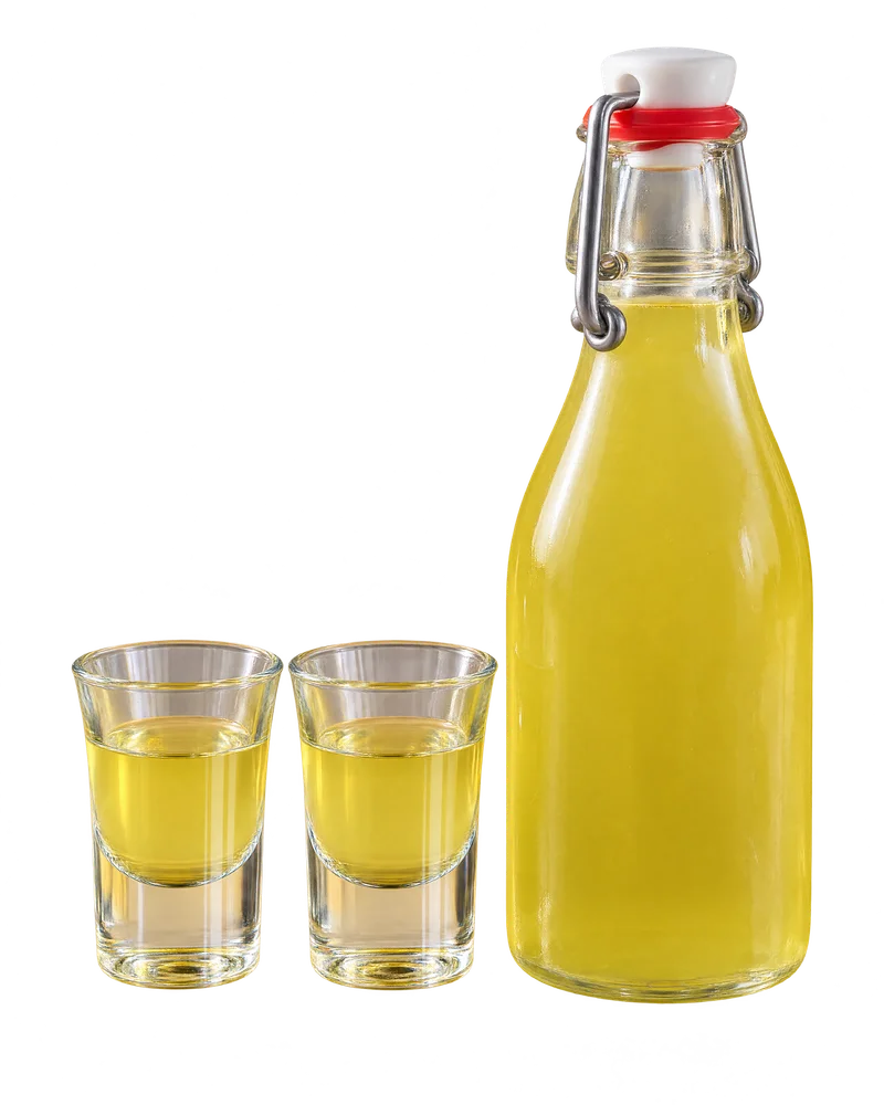 A bottle of limoncello beside two small glasses