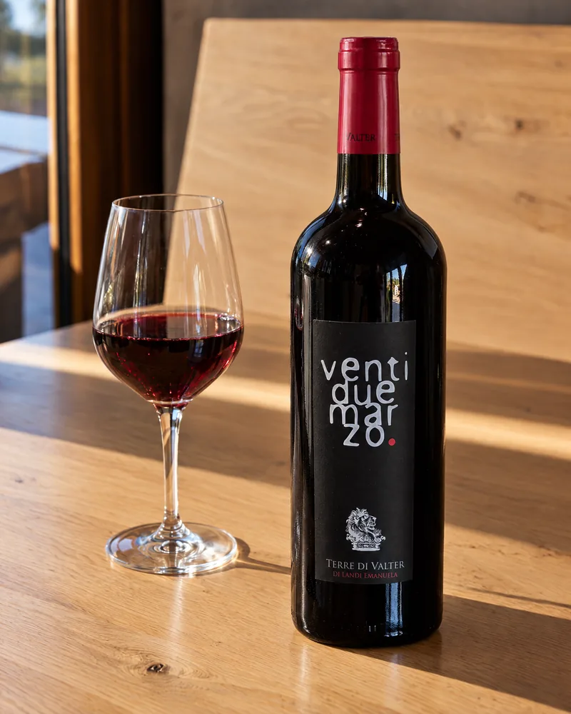 A bottle of Ventidue Marzo beside a glass of red wine