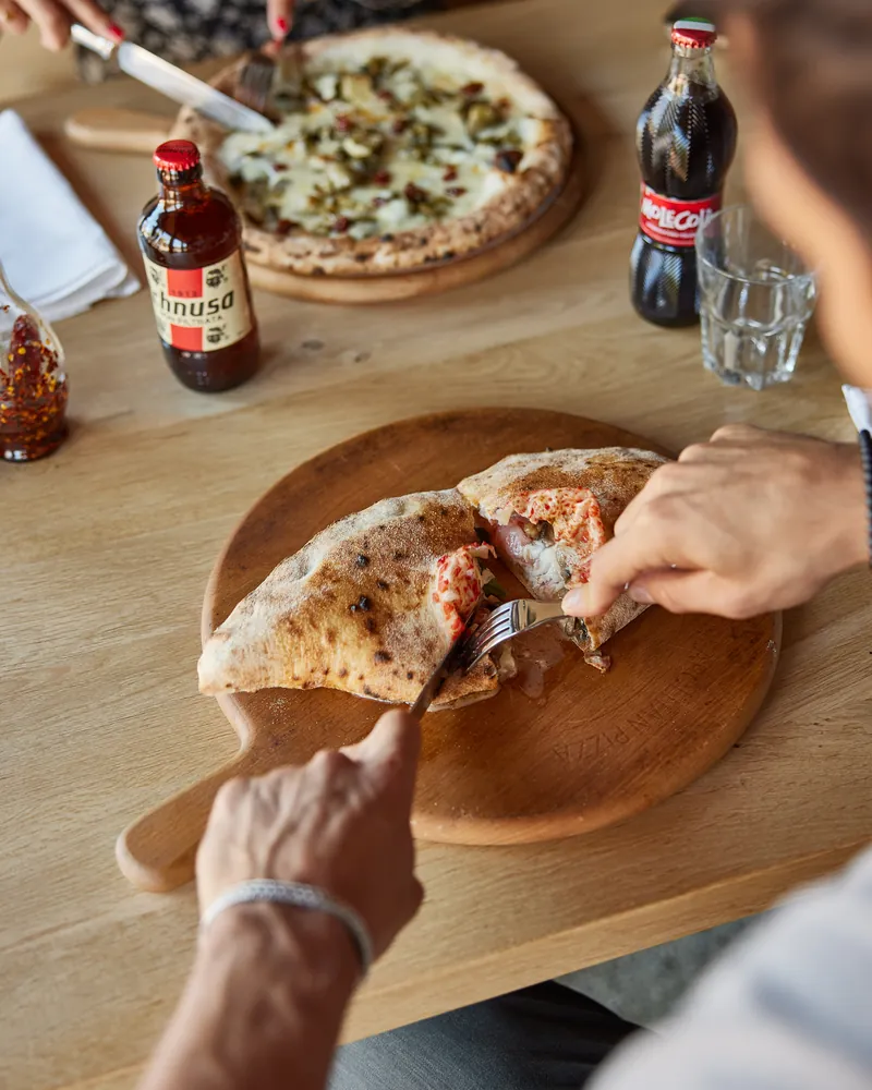 A calzone cut open at the table