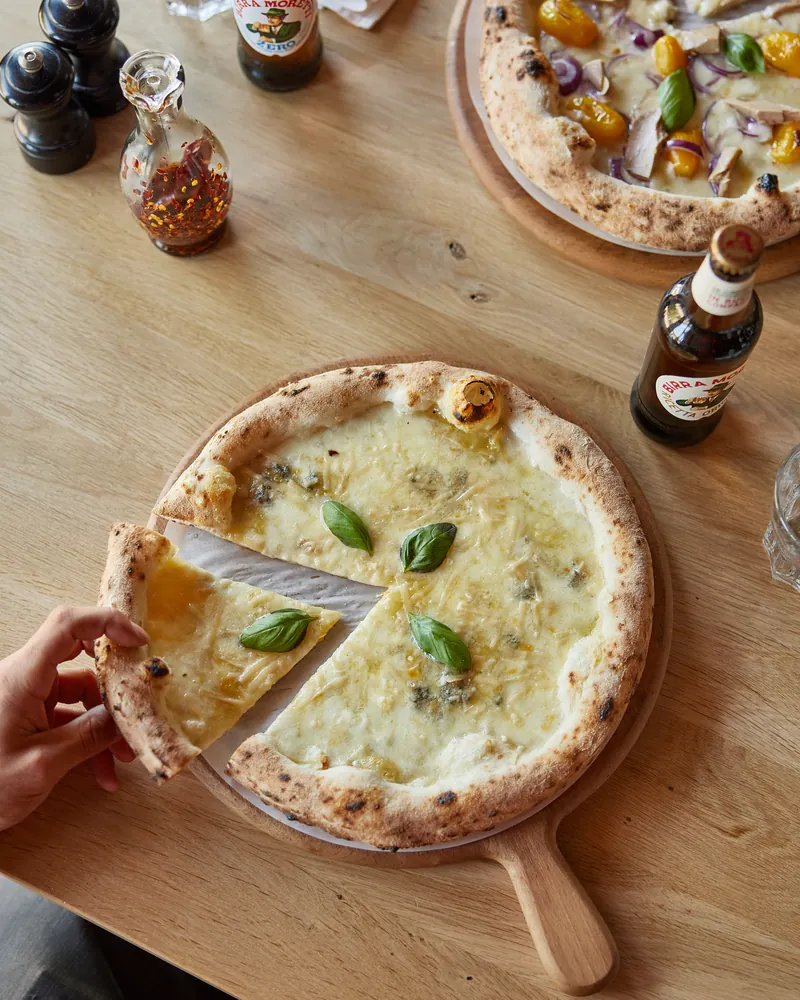A slice of white pizza lifted from the board