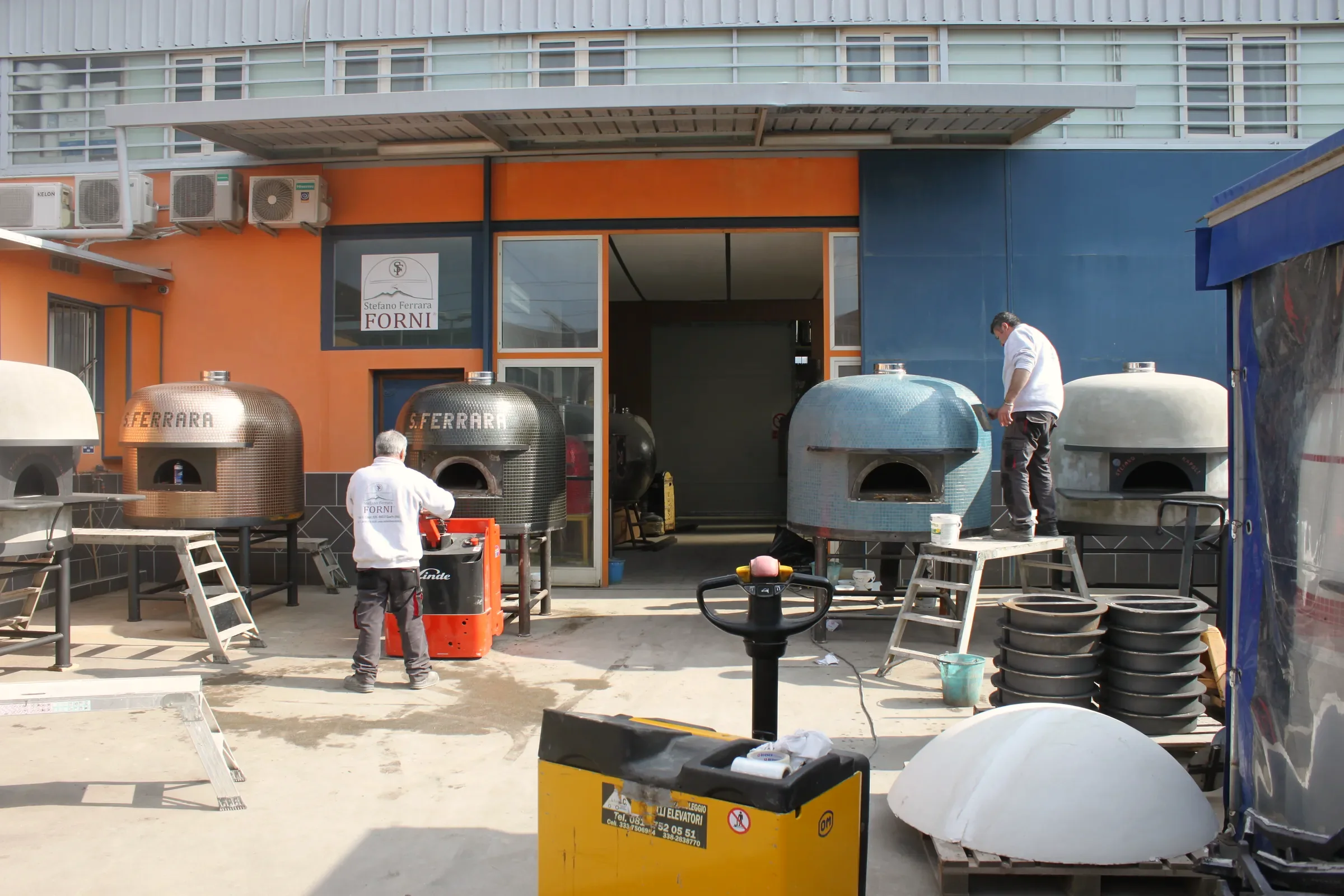 Wood-fired ovens being built in the yard of an oven maker near Naples
